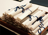 Decorative photo of a stack of rolled certificates